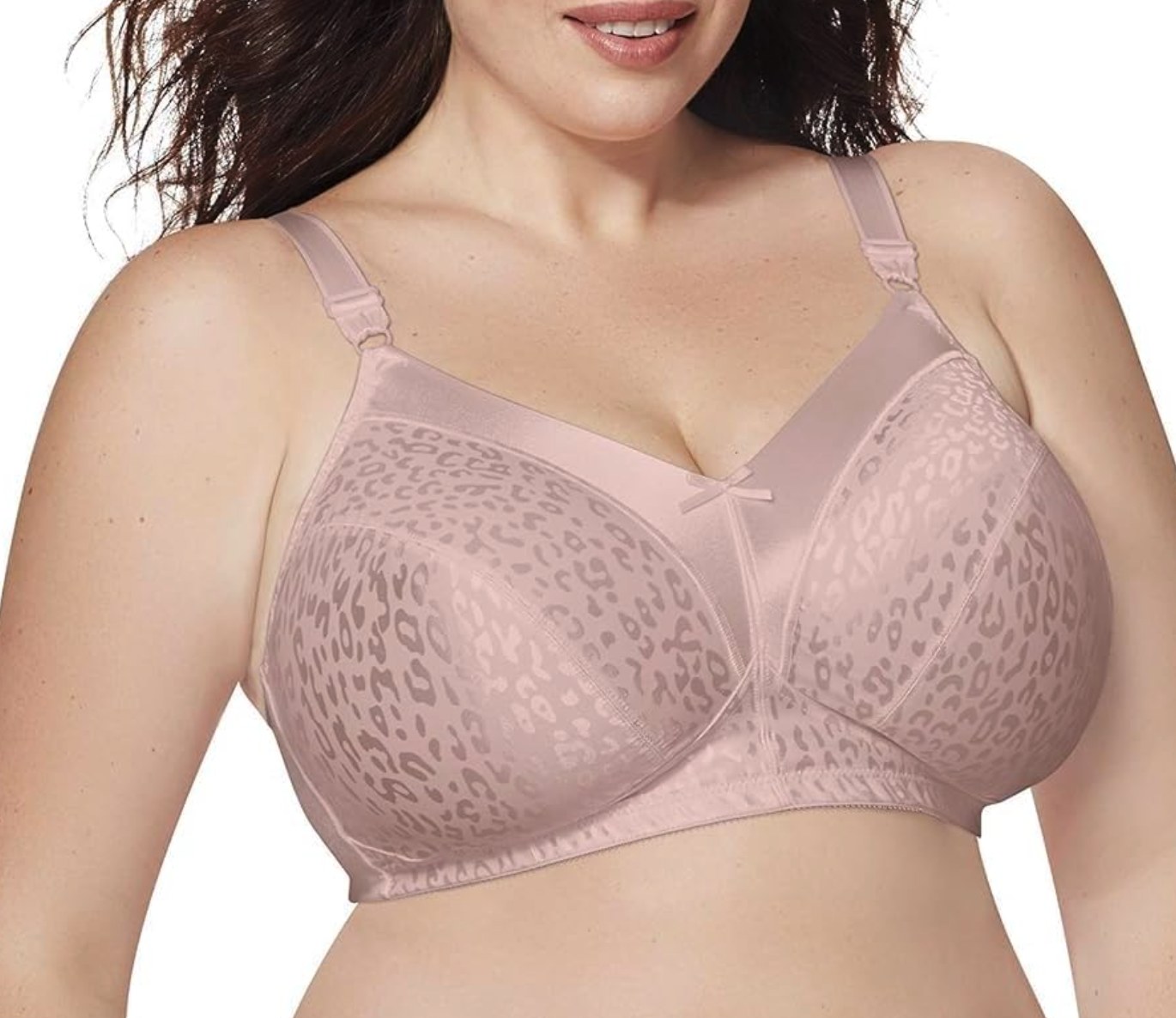 Close-up of a plus-size model wearing a blush pink wireless satin bra with tonal leopard print jacquard cups and bow detail